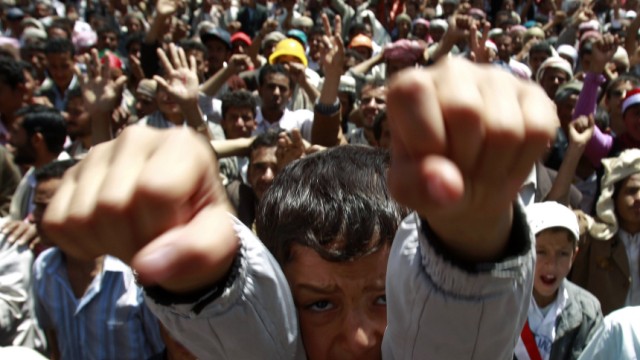 A boy shouts slogans with anti-government protesters during a rally demanding the ouster of Yemen's President's Ali Abdullah Saleh in Sanaa
