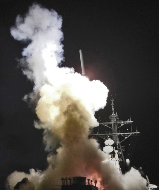 Arleigh Burke-class guided-missile destroyer USS Barry fires Tomahawk missile at Libya from Mediterranean Sea