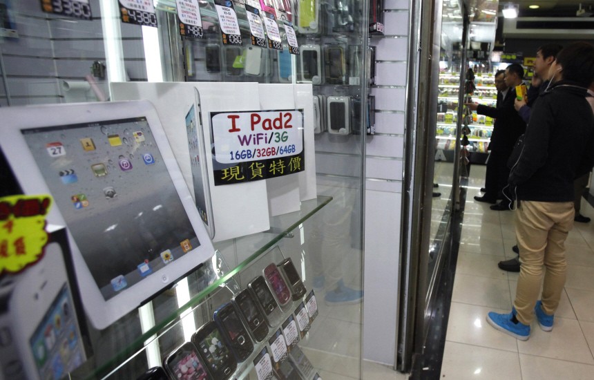 A mock up of an iPad 2 is displayed beside boxes of iPads at a mall in Hong Kong