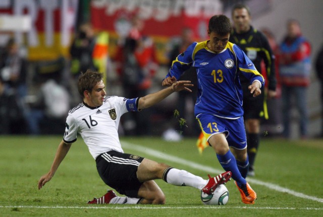 Germany's Lahm challenges Kazakhstan's Nurgaliyev during their Euro 2012 qualifying soccer match in Kaiserslautern