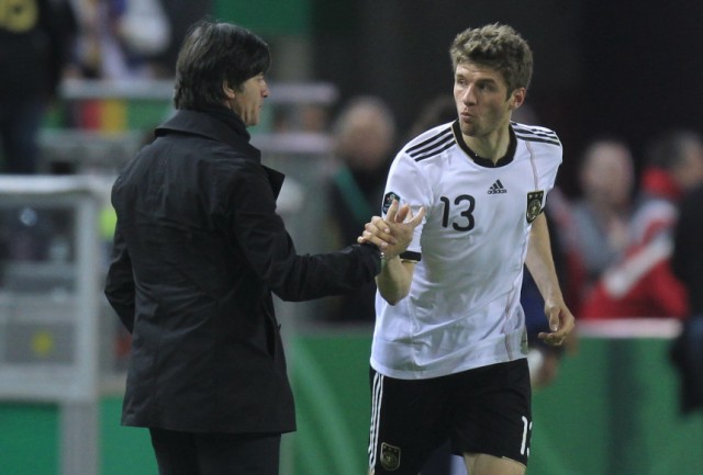 Germany's Mueller celebrates a goal with coach Joachim Loew during their Euro 2012 Group A qualifying soccer match against Kazakhstan in Kaiserslautern
