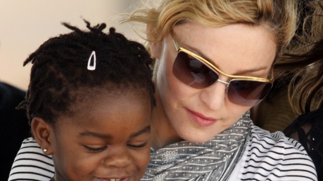 File photo of Madonna sitting with her adopted Malawian child Mercy James during a bricklaying ceremony at the site of her Raising Malawi Girls Academy