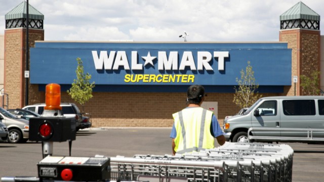 A worker brings carts back into a Walmart store in Westminster