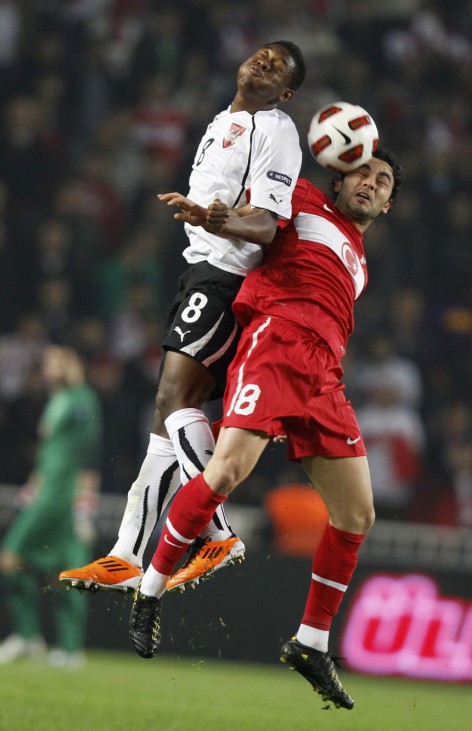 Austria's Alaba jumps for ball with Turkey's Inan during their Euro 2012 Group A qualifying soccer match in Istanbul
