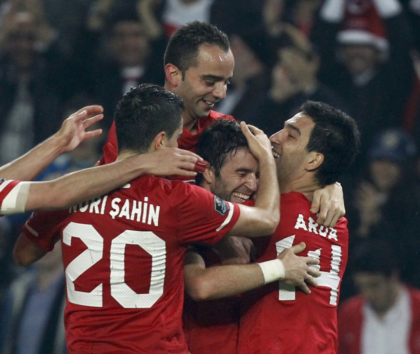 Turkey's Gonul celebrates with his teammates after scoring against Austria during their Euro 2012 Group A qualifying soccer match in Istanbul