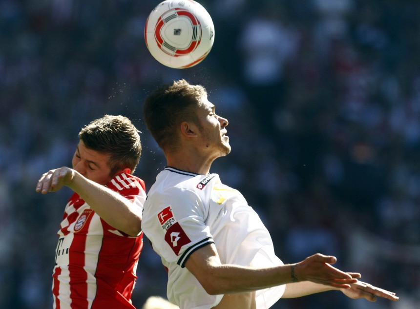 Kroos of Bayern challenges Neustaedter of Borussia during their Bundesliga soccer match in Munich