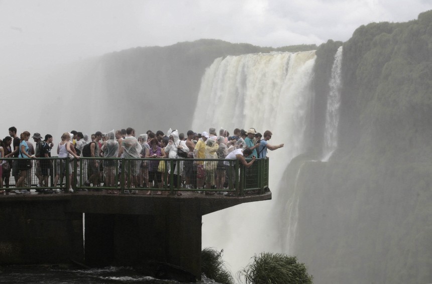 Tourists view the Iguazu waterfalls from the Brazilian side