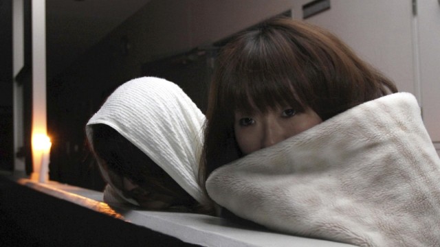 Nachbeben in Japan: Sendai: Sendai, 8. April: Nach dem erneuten Erdbeben sehen zwei Frauen nach den Schäden auf der Straße vor ihrem Wohnblock.