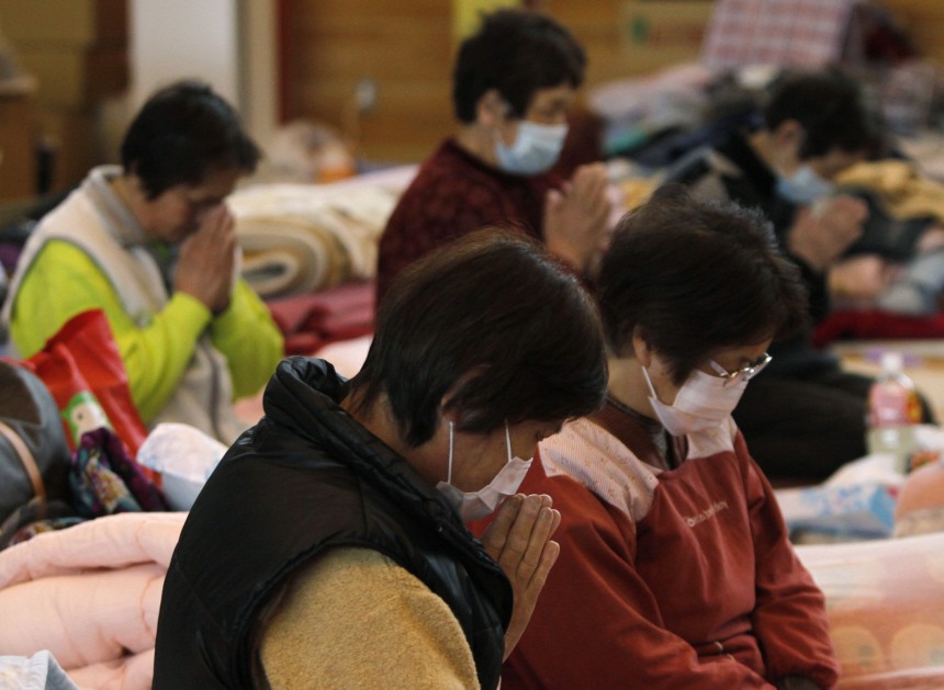 Victims of the March 11 earthquake and tsunami observe a minute of silence at 14:46 local time at a shelter in Kamaishi, Iwate prefecture