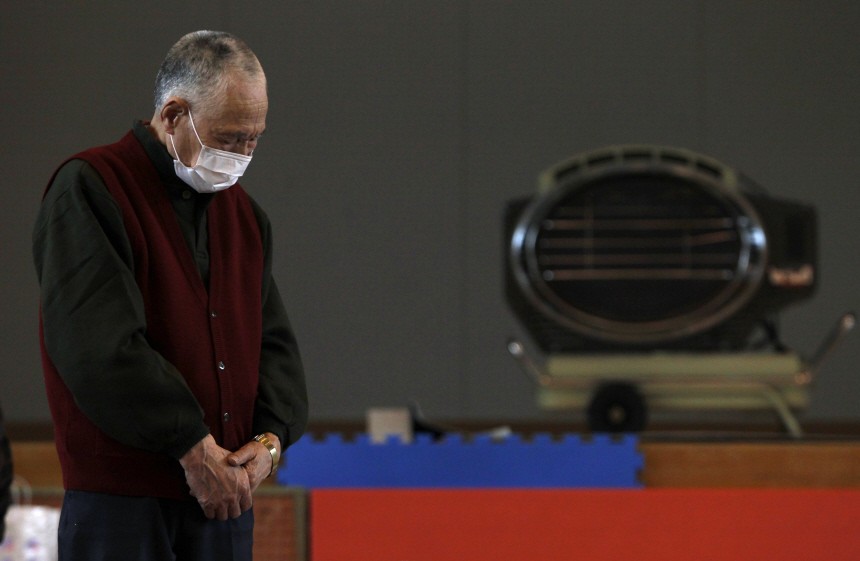 Victim of the March 11 earthquake and tsunami observes a minute of silence at 14:46 local time at a shelter in Kamaishi