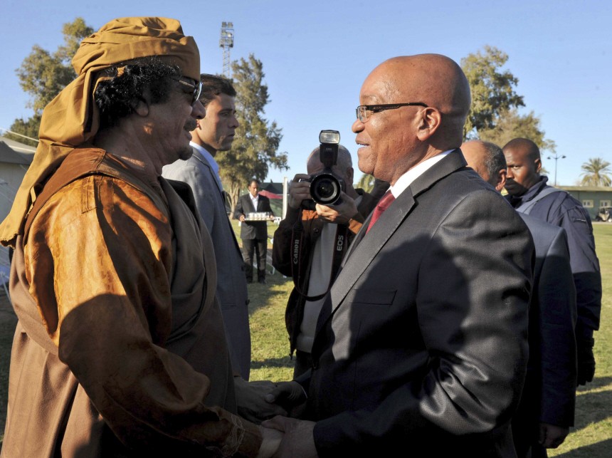Handout shows South Africa's President Jacob Zuma greeting Libya's Muammar Gaddaffi upon his arrival in Tripoli