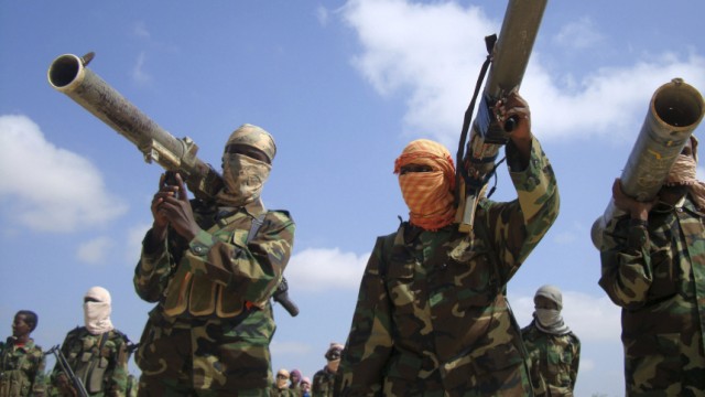 Members of the hardline al Shabaab Islamist rebel group hold their weapons in Somalia's capital Mogadishu