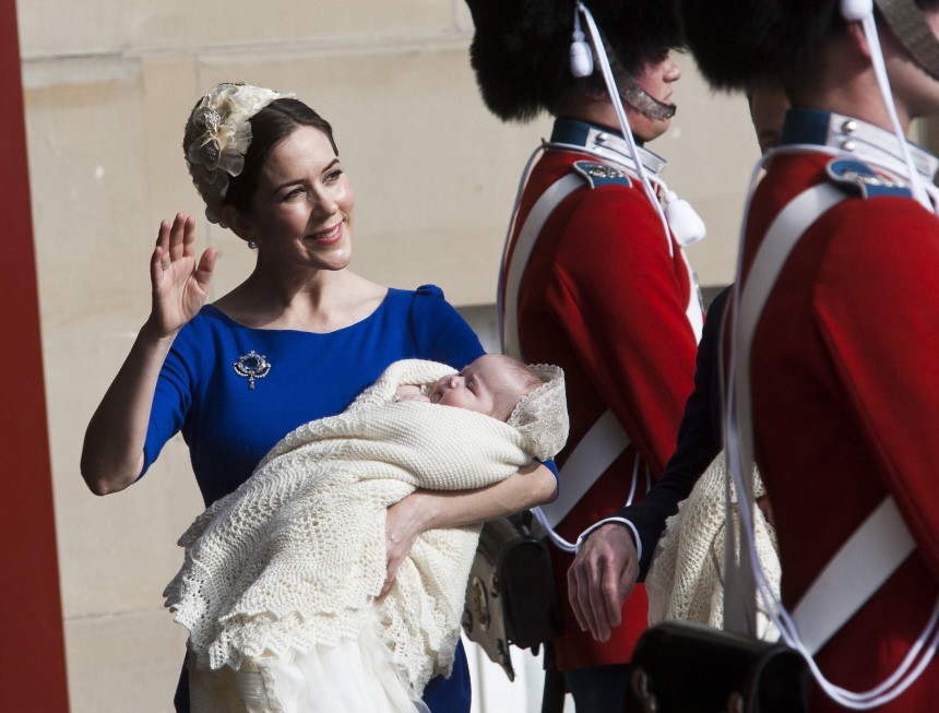 Danish Crown Princess Mary waves behind guards as she carries Princess Josephine Sophia Ivalo Mathilda in Copenhagen