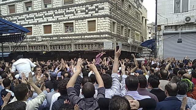 Mourners attend the funerals of protesters killed in earlier clashes in the Syrian city of Homs