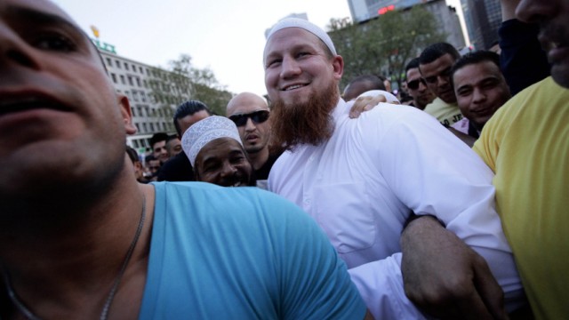 Islamic cleric Pierre Vogel is escorted by his bodyguards as he makes his way through thousands of his supporters after a pro-Islamic demonstration in downtown Frankfurt