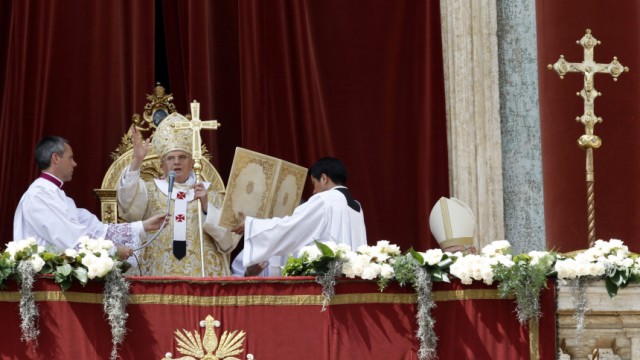 Pope Benedict XVI holds his cross as he gives the 'Urbi et Orbi' blessing in Saint Peter's Square in Vatican