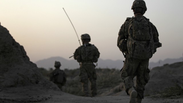 U.S. Army soldiers walk back to their base after a patrol in Arghandab Valley, north of Kandahar
