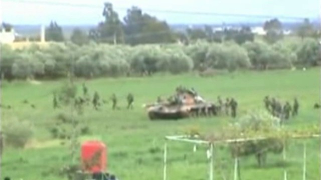 Still image taken from amateur video footage shows tanks and soldiers purportedly near Deraa