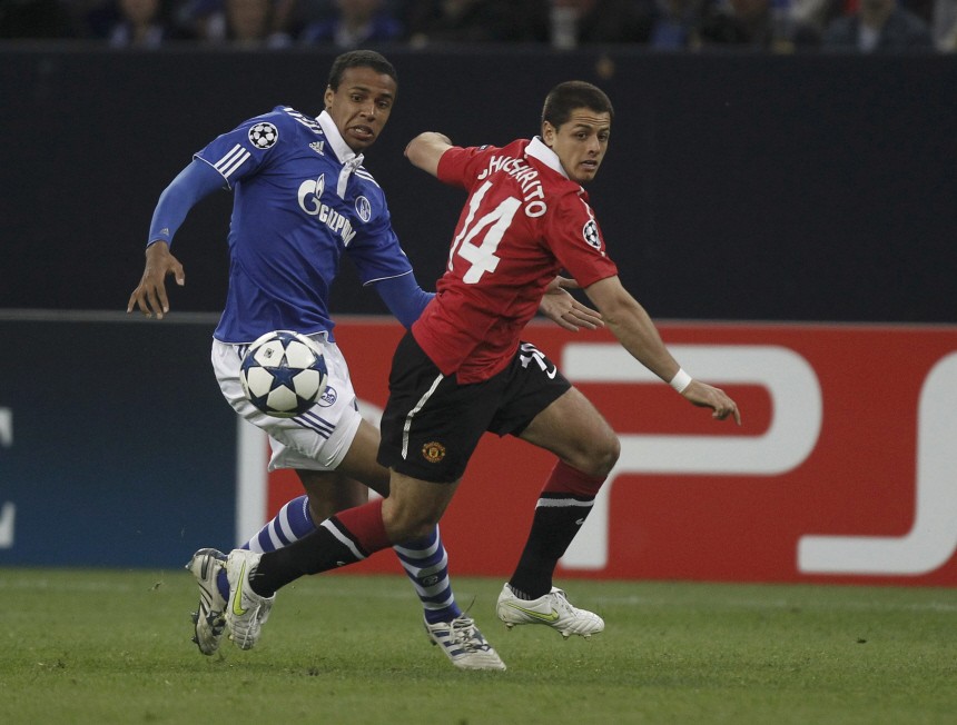 Matip of Schalke 04 challenges Manchester's Hernandez during their Champions League soccer match in Gelsenkirchen