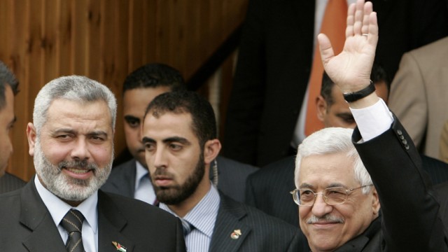 File photo of Palestinian President Abbas waving after his meeting with Prime Minister Ismail Haniyeh in Gaza
