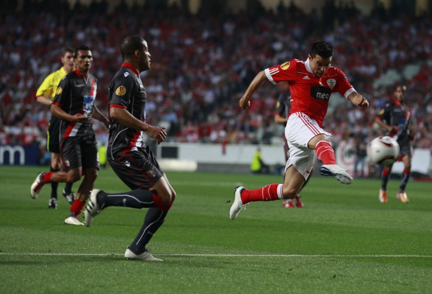 Benfica's Saviola shoots next to Braga's Rodriguez during the first leg of their Europa League semi-final soccer match at Luz stadium in Lisbon