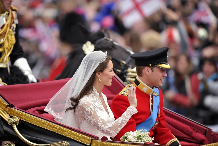 Britain's Catherine, Duchess of Cambridge, and Prince William travel to Buckingham Palace in the 1902 State Landau along the Procession Route, after their wedding in Westminster Abbey, in central London