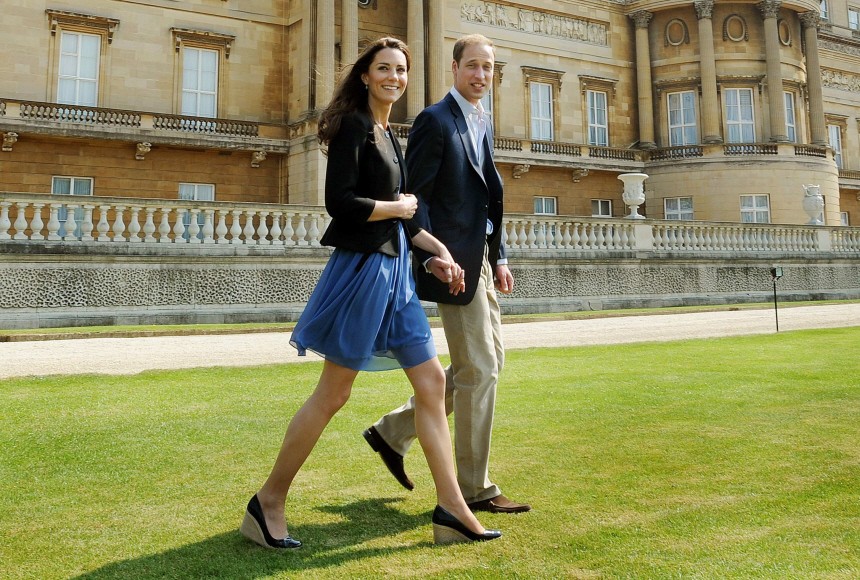 Britain's Prince William and Catherine, Duchess of Cambridge, walk together in Buckingham Palace in central London