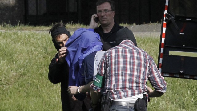 Police escort a suspected member of al Qaeda as they arrive at the federal supreme court in Karlsruhe