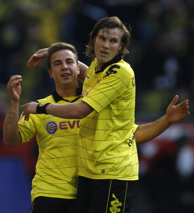 Borussia Dortmund's Grosskreutz and Goetze celebrate a goal against Freiburg during the German Bundesliga soccer match in Dortmund