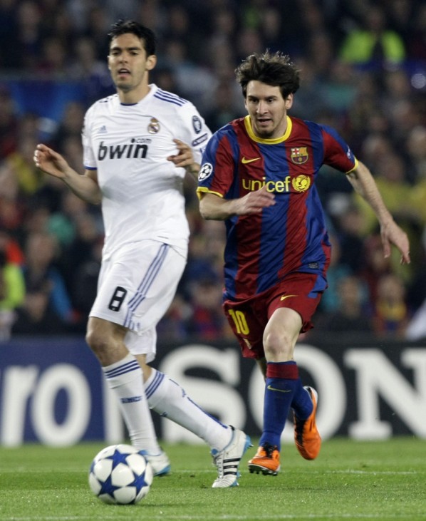 Real Madrid's Kaka and Barcelona's Messi run towards the ball during their Champions League semi-final second leg soccer match in Barcelona