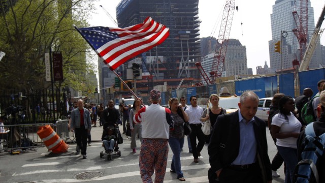 Man carries American flag outside World Trade Center site in New York after killing of Osama Bin Laden