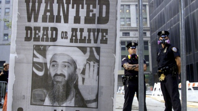 File photo of police standing near a wanted poster of Saudi-born militant Osama bin Laden in New York