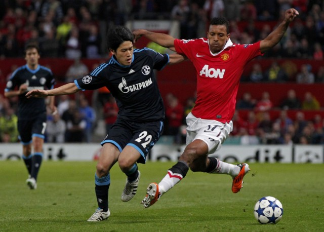 Schalke 04's Atsuto Uchida challenges Luis Nani during their Champions League semi-final second leg soccer match at Old Trafford in Manchester.