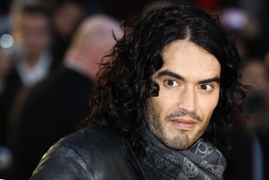British actor Russell Brand poses for photographers as he arrives for the European premiere of 'Despicable Me' at Leicester Square in London