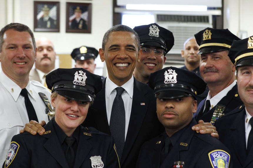 U.S. President Barack Obama poses with officers of the First Precinct police station in lower Manhattan during a visit to the World Trade Center site in New York