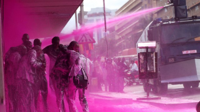 Police spray Ugandan opposition party leaders with coloured water during demonstrations in the capital Kampala