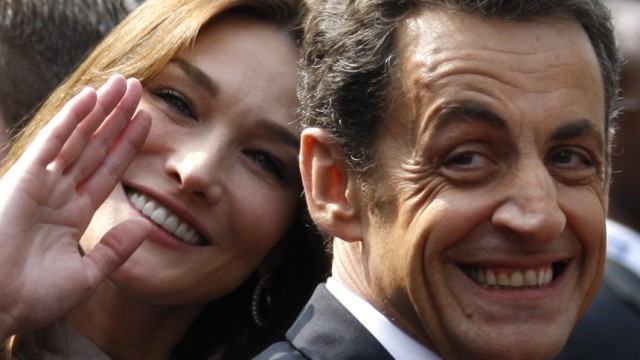 File photo of France's President Nicolas Sarkozy and first lady Carla Bruni-Sarkozy smiling in Strasbourg