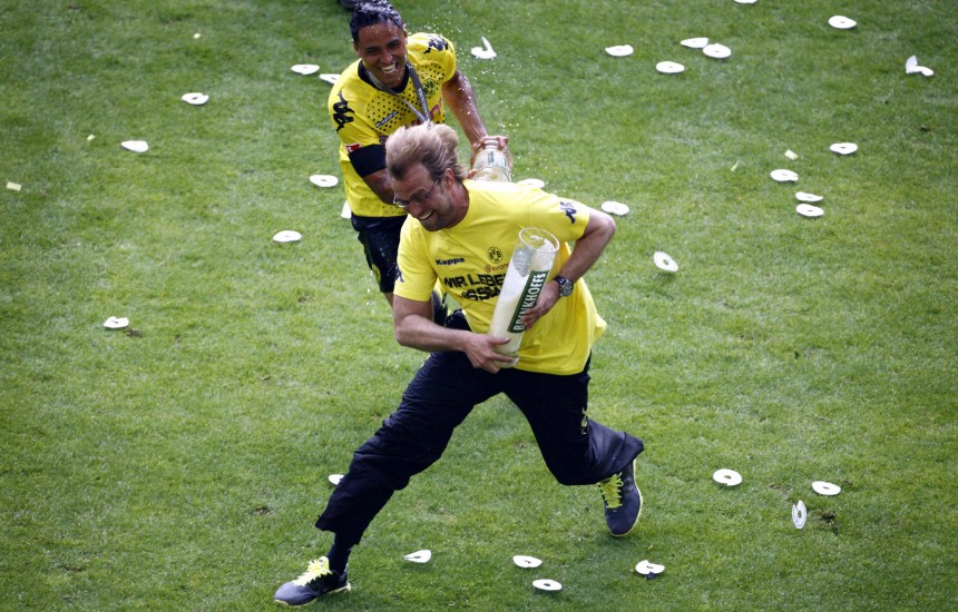 Borussia Dortmund's Da Silva pours beer over coach Klopp after winning the German soccer championship in Dortmund