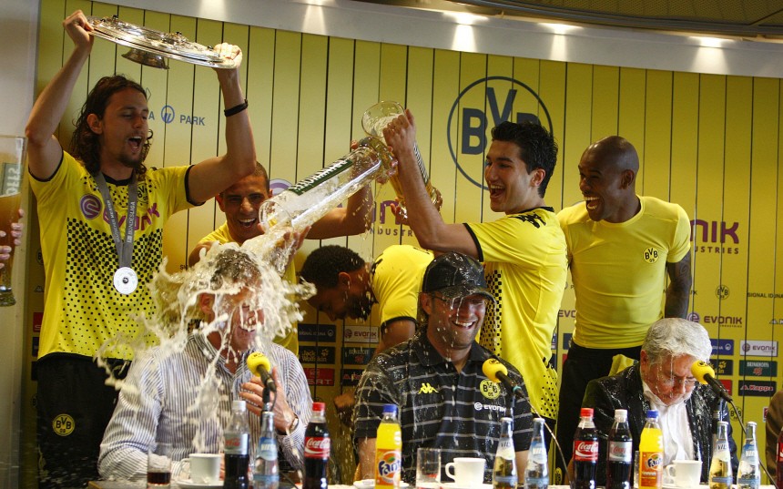 Dortmund's player Sahin pours beer over Watzke after winning the German soccer championship after their German Bundesliga soccer match against Frankfurt in Dortmund