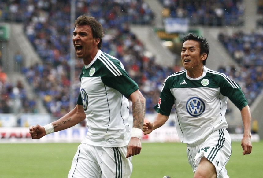 Wolfsburg's Mandzukic celebrates a goal with Hasebe during their German Bundesliga first division soccer match against TSG Hoffenheim in Sinnsheim