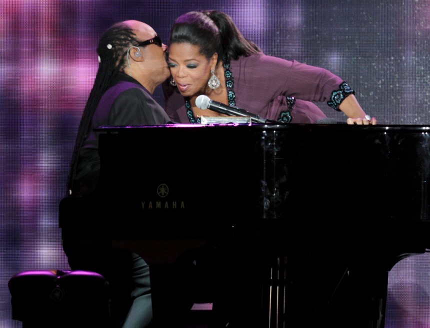 Oprah Winfrey greets singer Stevie Wonder during the taping of 'Oprah's Surprise Spectacular' in Chicago