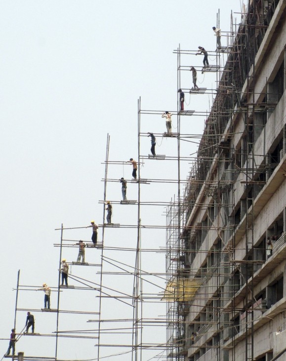 Labourers work at the construction site of a commercial complex in the eastern Indian city of Bhubaneswar