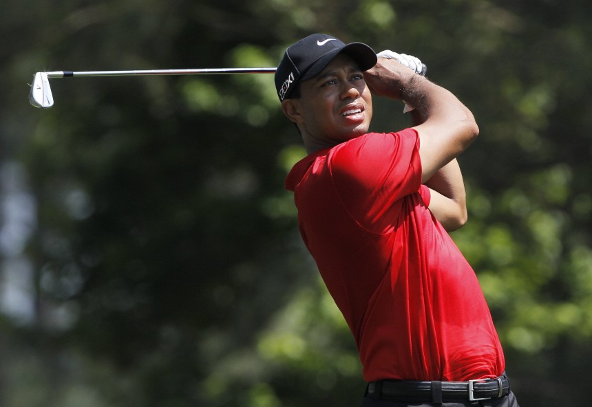 File picture shows Tiger Woods of the U.S. watching his tee shot on the fourth hole at 2011 Masters golf tournament in Augusta