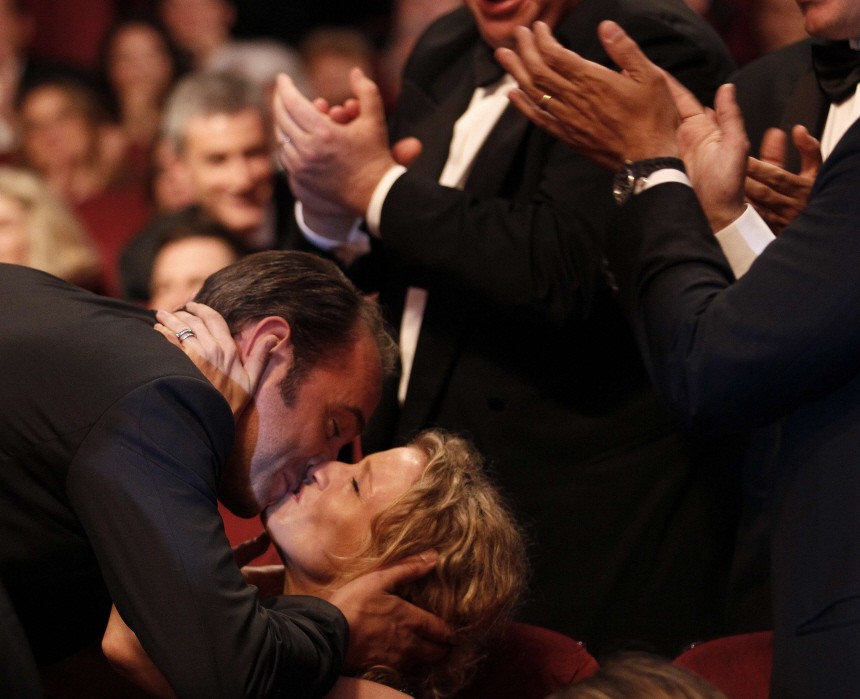 Actor Dujardin reacts after receiving the Best Actor award during the closing ceremony of the 64th Cannes Film Festival