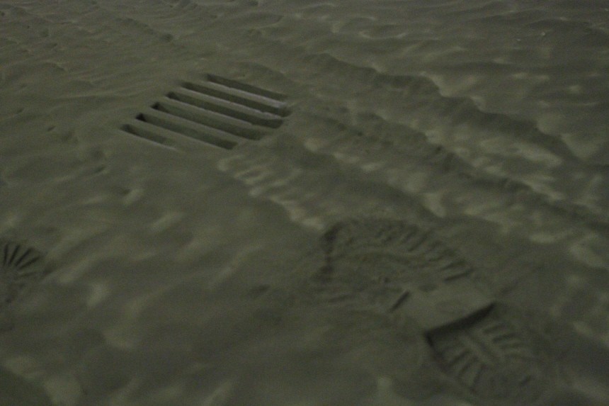 Footprints are seen on a surface of ash outside a gas station in Kirkjubaejarklaustur