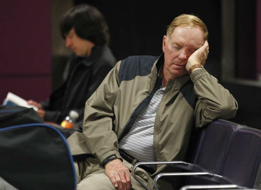 A man sleeps at Edinburgh Airport in Scotland