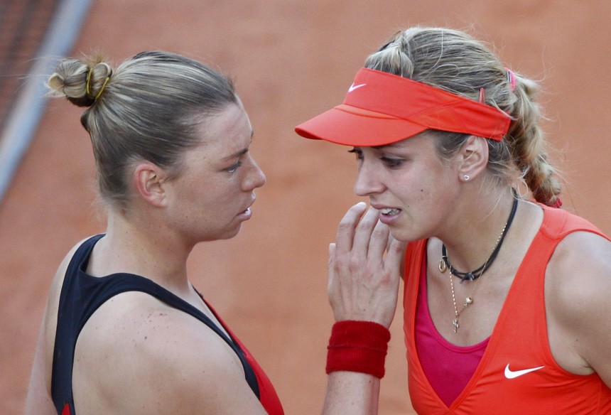 Zvonareva of Russia comforts Lisicki of Germany after winning during the French Open tennis tournament at the Roland Garros stadium in Paris