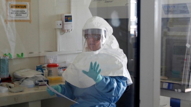 A laboratory specialist examines specimens of the Ebola virus at the Uganda virus research centre in Entebbe