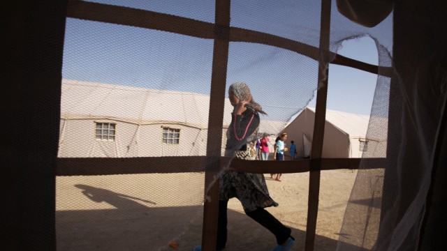 Libyan refugee is seen from inside a tent at a refugee camp in Dehiba