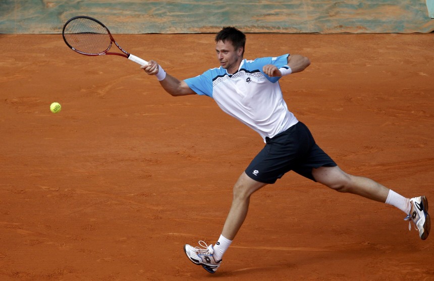 Soderling of Sweden returns the ball to Simon of France during  the French Open tennis tournament at the Roland Garros stadium in Paris